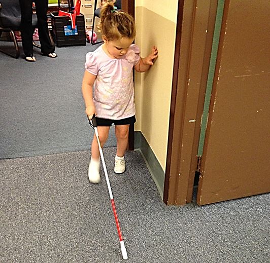 A blind pre schooler learning to navigate with a white cane